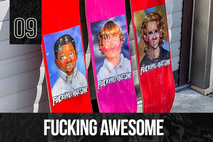 Three Fucking Awesome skateboard decks in red and pink, each with a childhood portrait graphic and bold white logo, lined up against a garage door.