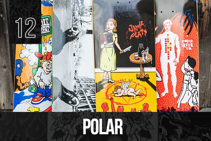 Four Polar Skate Co. decks with varied artistic graphics, including cartoon, photographic, and surreal illustrations, displayed upright against a wooden wall.