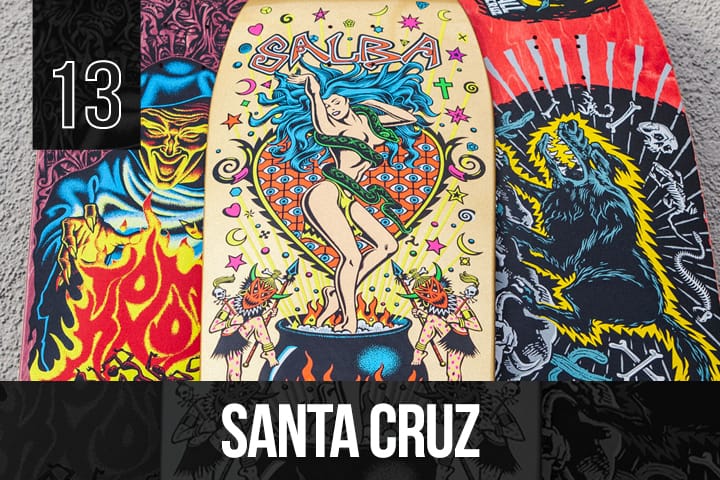 Three Santa Cruz skateboard decks with retro-inspired, colorful graphics, including a dancing woman, monsters, and flames, arranged side by side.