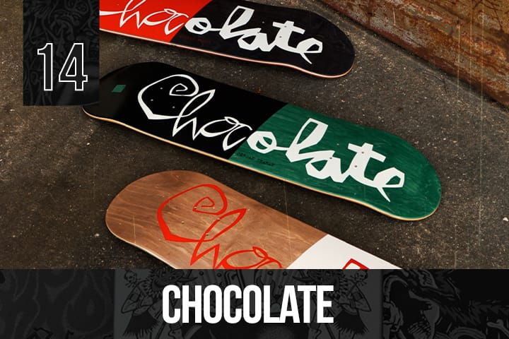 Three Chocolate Skateboards decks with bold handwritten-style Chocolate logos in red, green, and white, displayed on wood and black backgrounds.