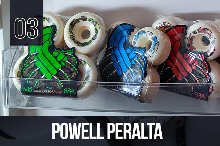 Assorted Powell Peralta wheels with dragon and rat designs, displayed in clear packaging, suitable for collectors and skateboarders.
