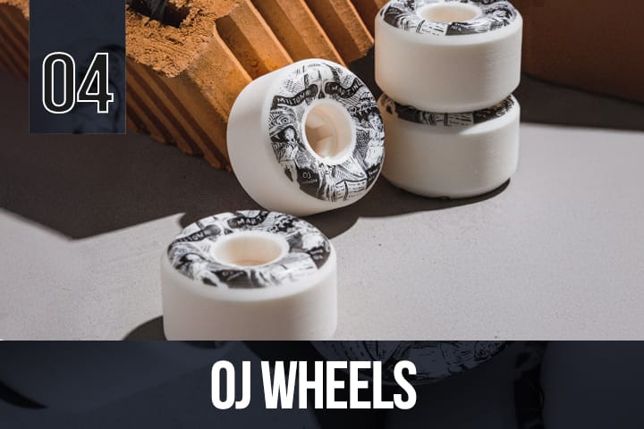 Four OJ skateboard wheels with detailed black and white artwork around the edge, arranged in a group for product presentation.