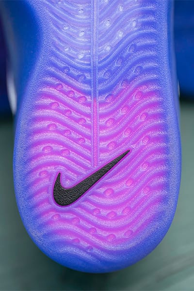 Detailed view of the purple-blue outsole of the Nike SB Zoom Nyjah 4 with visible black Swoosh logo