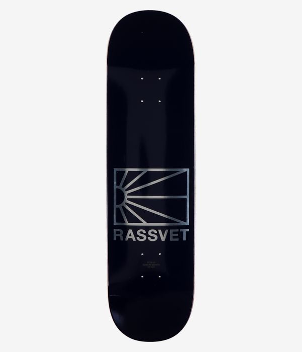 RASSVET | PACCBET Logo 8.3" Skateboard Deck, full bottom view — solid black deck with centered metallic silver rectangular sunburst logo and large 'RASSVET' text; clean studio image; white background