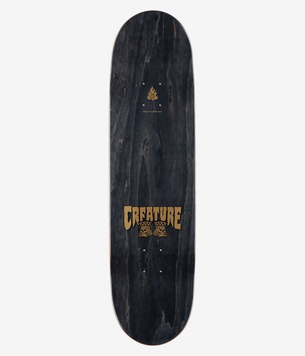 Creature Heshking Twin 8,5"-Skateboard-Deck, Ansicht von oben: schwarzes Deck in Holzoptik mit zentriertem gold-beigem „Creature“-Schriftzug, zwei kleinen Totenköpfen darunter und einem kleinen Flammenlogo im oberen Bereich. Klares Studiobild; weißer Hintergrund.