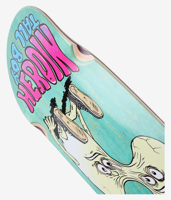 Gros plan sur la planche de skateboard « Merged Tall Boy 10,25 pouces » de la marque Heroin Skateboards, sur fond turquoise, avec en haut le mot « HEROIN » en grosses lettres roses et un personnage de bande dessinée beige aux contours noirs. Image de studio nette ; fond blanc.